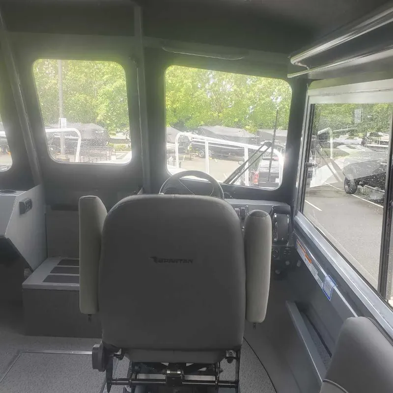 Slide: The Image of Interior of 2024 Spartan Maximus 240 boat, featuring the helm and captain's chair. - 5