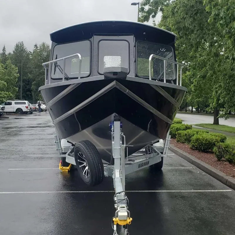 Slide: The Image of 2024 Spartan Maximus 240 boat on trailer in parking lot. - 2