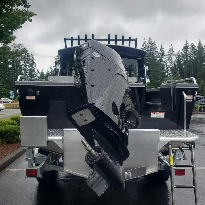 Slide: The Image of 2024 Spartan Maximus 240 boat with powerful outboard motor in a parking lot. - 3