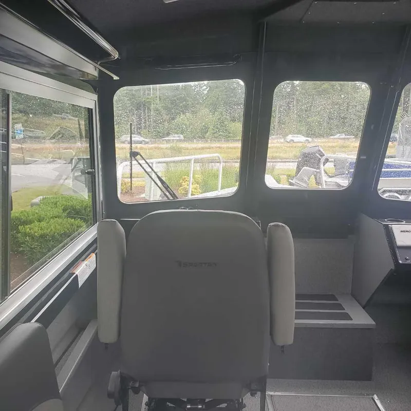 Slide: The Image of Interior of 2024 Spartan Maximus 240 boat with captain's chair and large windows. - 4