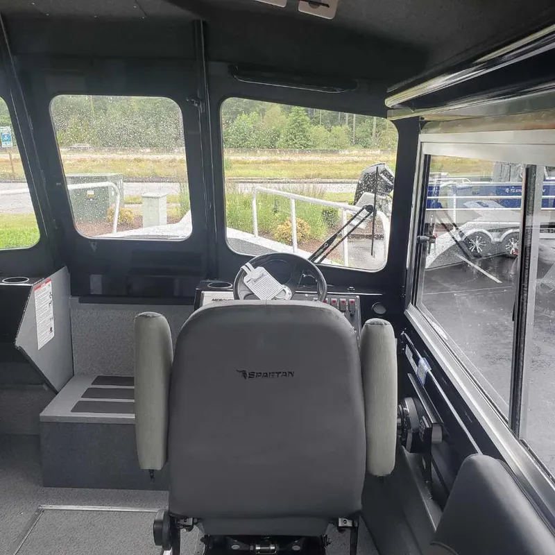 Slide: The Image of Interior of 2024 Spartan Maximus 240 boat cockpit with steering wheel and captain's chair. - 5