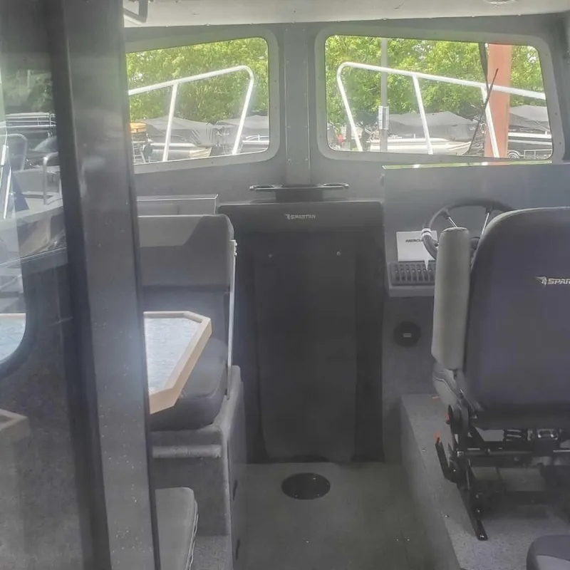 Slide: The Image of Interior of 2024 Spartan 2600 Olympia boat with seating and control area. - 22