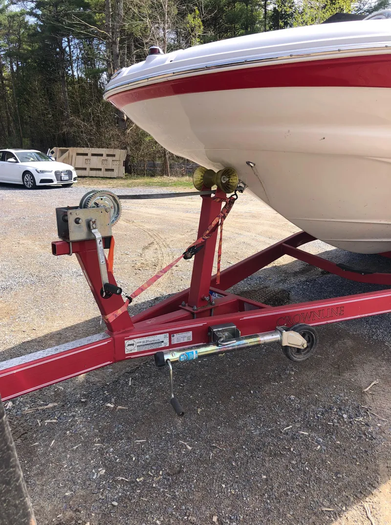 Slide: The Image of 2007 Crownline 240 EX boat on red trailer, parked outdoors. - 10