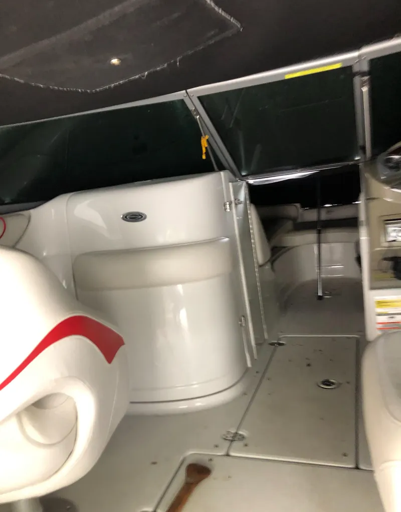 Slide: The Image of 2007 Crownline 240 EX boat interior with white seating and red accents. - 14