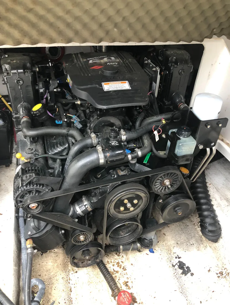 Slide: The Image of Engine of a 2007 Crownline 240 EX boat, showcasing belts and components. - 16