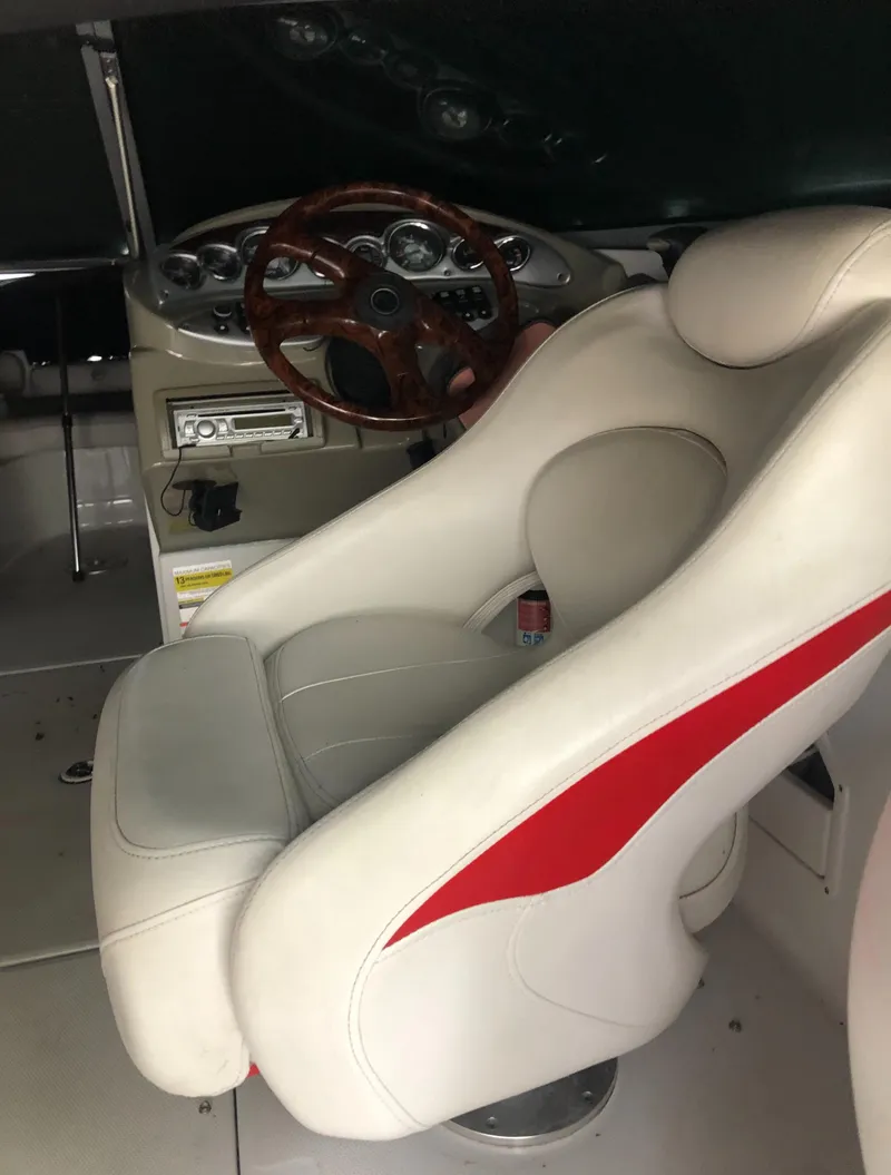Slide: The Image of 2007 Crownline 240 EX boat interior with white and red captain's seat and dashboard. - 20