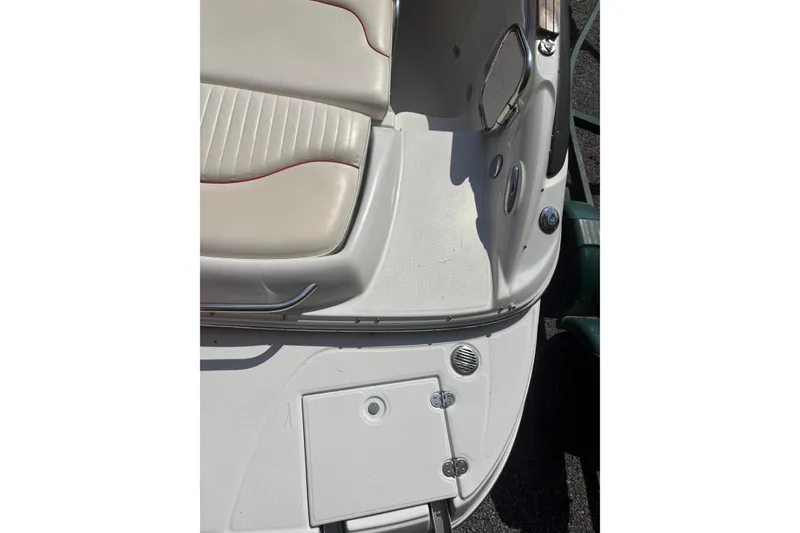 Slide: The Image of 2007 Crownline 240 EX boat interior with beige seating and storage compartment. - 24