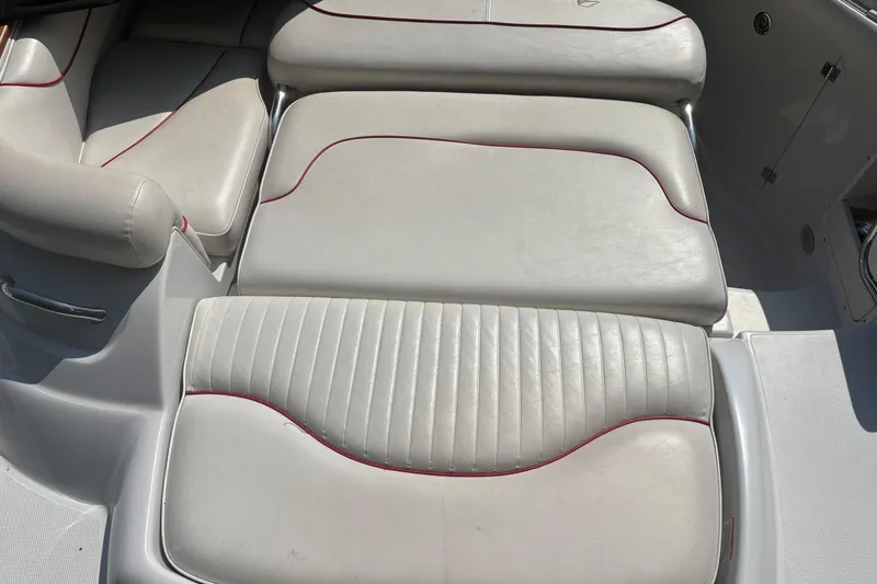 Slide: The Image of 2007 Crownline 240 EX boat interior with cushioned seating and red trim. - 26