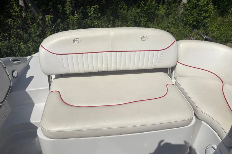 Slide: The Image of 2007 Crownline 240 EX boat seating with white upholstery and red accents. - 28