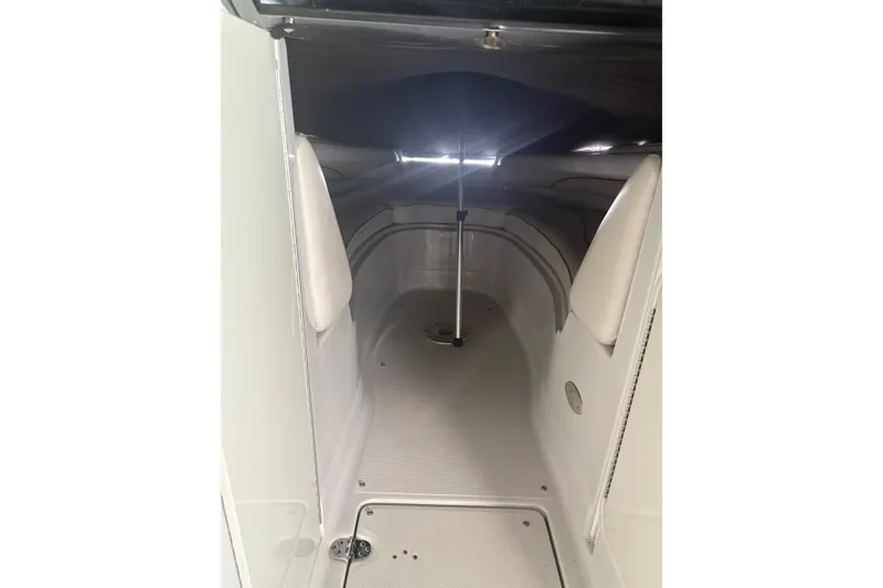 Slide: The Image of Interior cabin of a 2007 Crownline 240 EX boat, featuring sleek white design. - 29