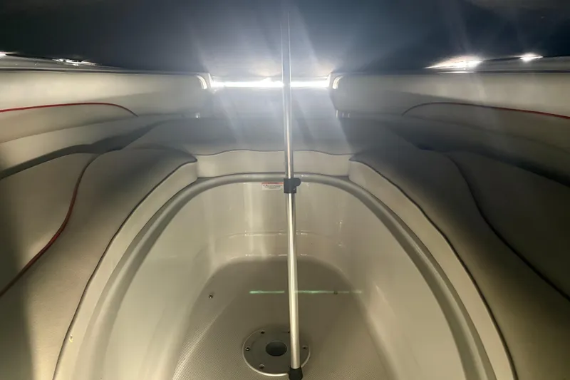 Slide: The Image of Interior view of a 2007 Crownline 240 EX boat cabin with seating and pole support. - 30