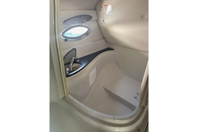Slide: The Image of 2007 Crownline 240 EX boat interior with sink and porthole window. - 31