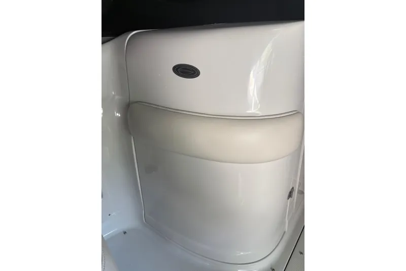 Slide: The Image of 2007 Crownline 240 EX boat interior detail with white panel and cushioned seat. - 32