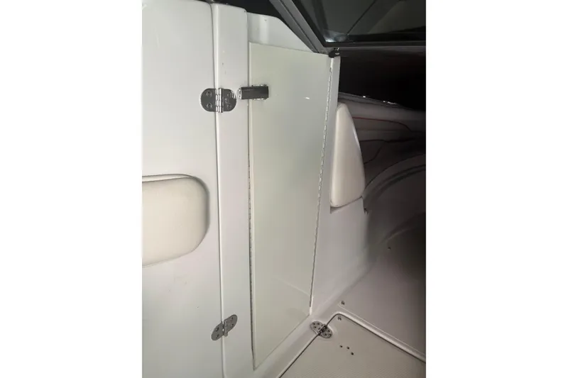 Slide: The Image of 2007 Crownline 240 EX boat interior with white seating and door detail. - 33