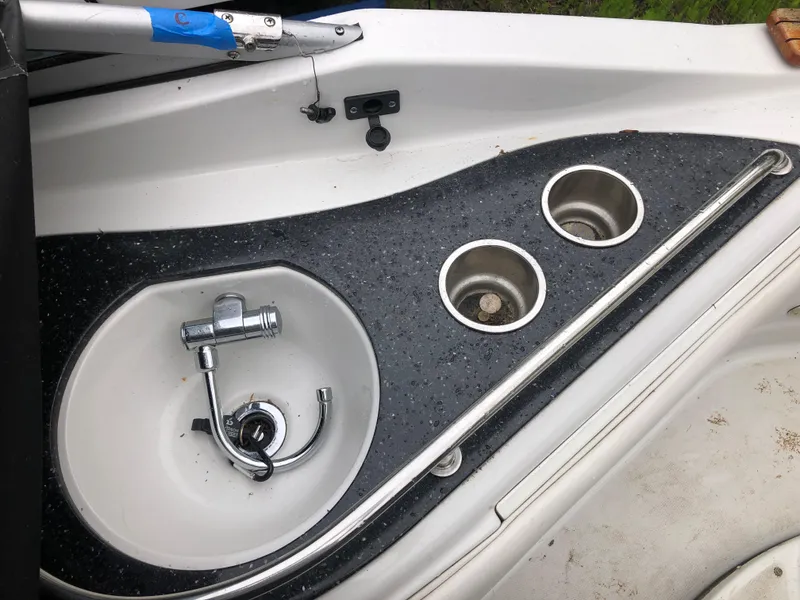 Slide: The Image of 2007 Crownline 240 EX boat sink and cup holders on deck. - 5