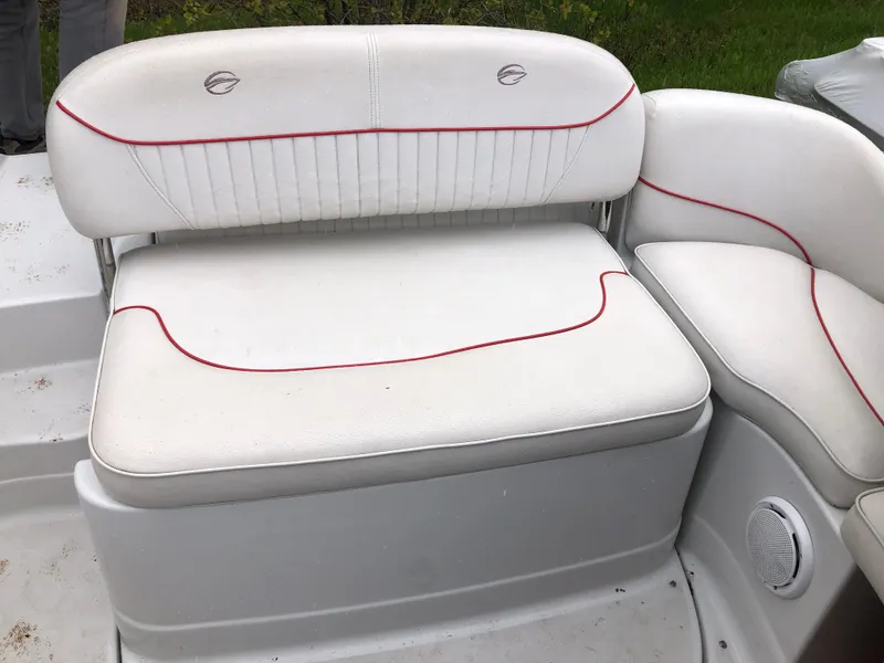 Slide: The Image of 2007 Crownline 240 EX boat seating with white upholstery and red accents. - 7