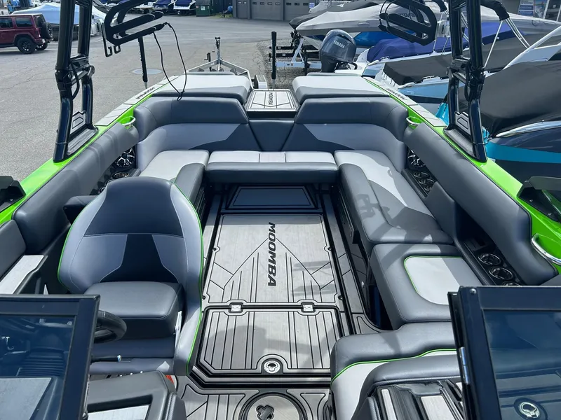 Slide: The Image of 2022 Moomba Mojo boat interior with gray and green seating. - 3