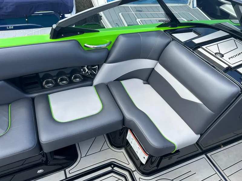 Slide: The Image of 2022 Moomba Mojo boat interior with gray and green seating. - 5