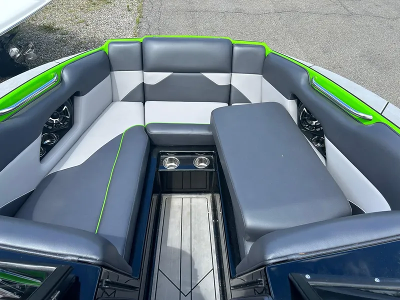 Slide: The Image of 2022 Moomba Mojo boat interior with gray and green seating. - 7