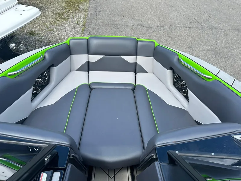 Slide: The Image of 2022 Moomba Mojo boat interior with gray and green seating. - 8
