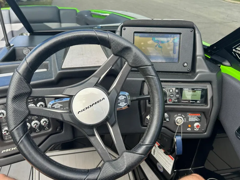 Slide: The Image of 2022 Moomba Mojo boat dashboard with steering wheel and control panel. - 9