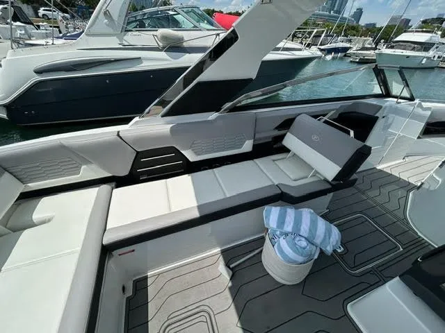 Slide: The Image of 2022 Cobalt A29 boat interior with seating and towel bucket on deck. - 10