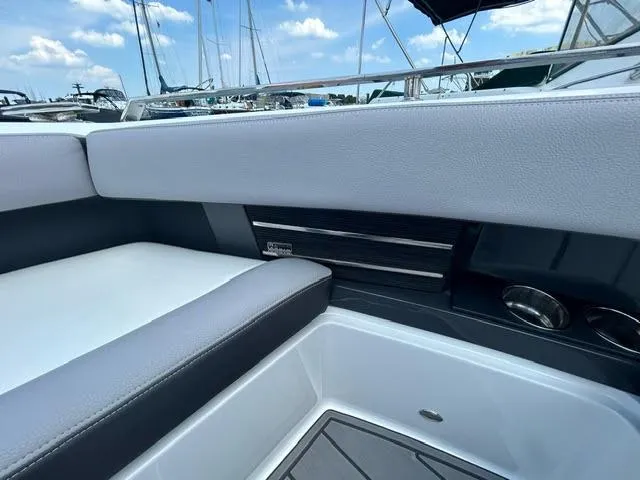 Slide: The Image of 2022 Cobalt A29 boat interior with cushioned seating and sleek design. - 14