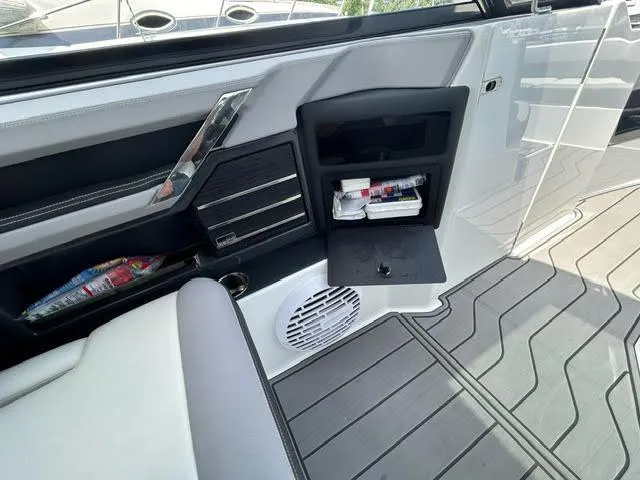 Slide: The Image of 2022 Cobalt A29 boat interior with storage compartments and speaker. - 15