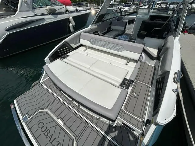 Slide: The Image of 2022 Cobalt A29 boat with luxurious seating and swim platform at marina. - 16