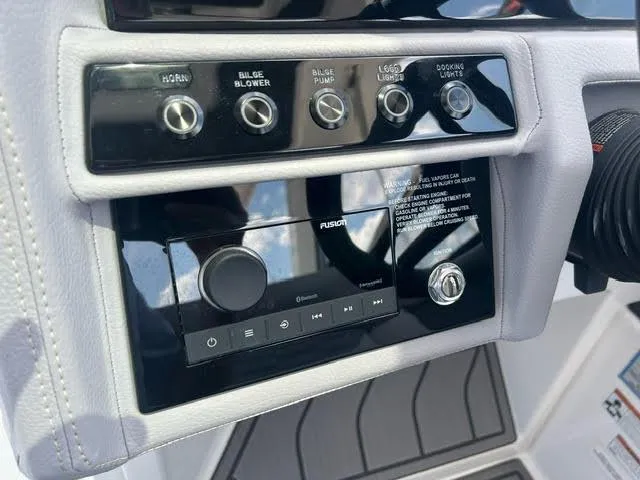 Slide: The Image of 2022 Cobalt A29 boat control panel with switches and Fusion audio system. - 18