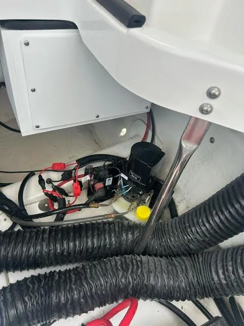 Slide: The Image of 2022 Cobalt A29 boat engine compartment with wiring and components. - 22