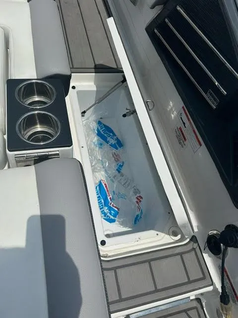 Slide: The Image of 2022 Cobalt A29 boat with built-in cooler and cup holders. - 26