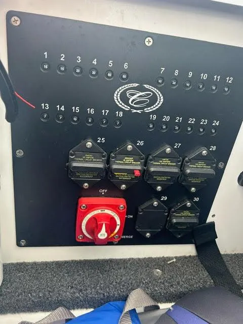 Slide: The Image of Control panel of a 2022 Cobalt A29 boat with switches and circuit breakers. - 27