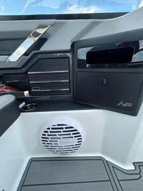 Slide: The Image of Interior of a 2022 Cobalt A29 boat featuring a speaker and storage compartments. - 30