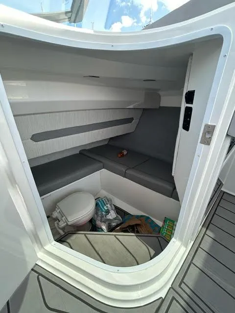Slide: The Image of 2022 Cobalt A29 boat interior cabin with seating and toilet. - 31