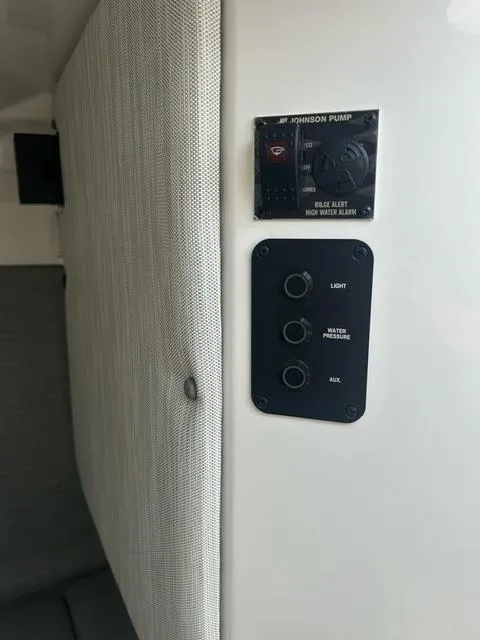 Slide: The Image of Control panel in 2022 Cobalt A29 boat with Johnson Pump and various switches. - 32