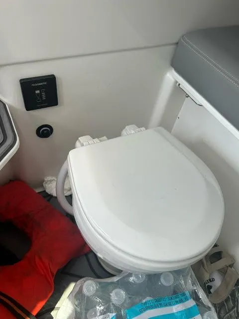 Slide: The Image of 2022 Cobalt A29 boat bathroom with toilet and safety equipment. - 33