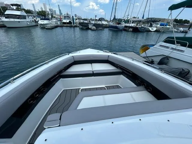 Slide: The Image of 2022 Cobalt A29 boat interior at a marina with yachts and sailboats. - 34