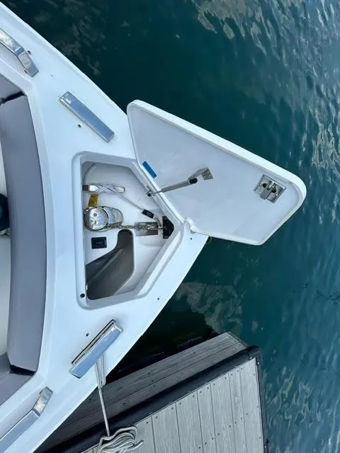 Slide: The Image of 2022 Cobalt A29 boat bow storage compartment open at dock. - 35