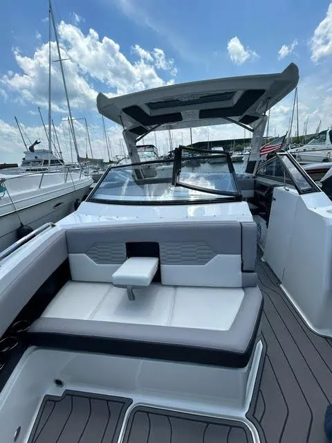 Slide: The Image of 2022 Cobalt A29 boat with sleek design and spacious seating at a marina. - 36