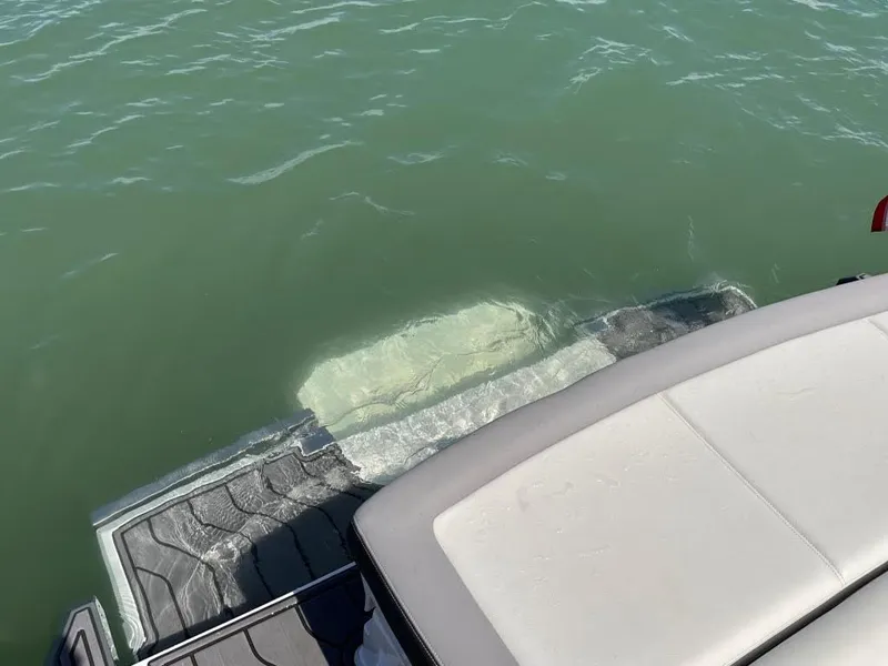 Slide: The Image of 2022 Cobalt A29 boat swim platform partially submerged in water. - 38