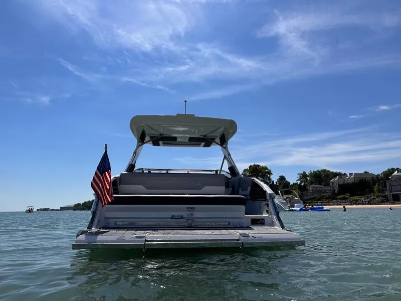 Slide: The Image of 2022 Cobalt A29 boat on water with American flag, clear sky background. - 5