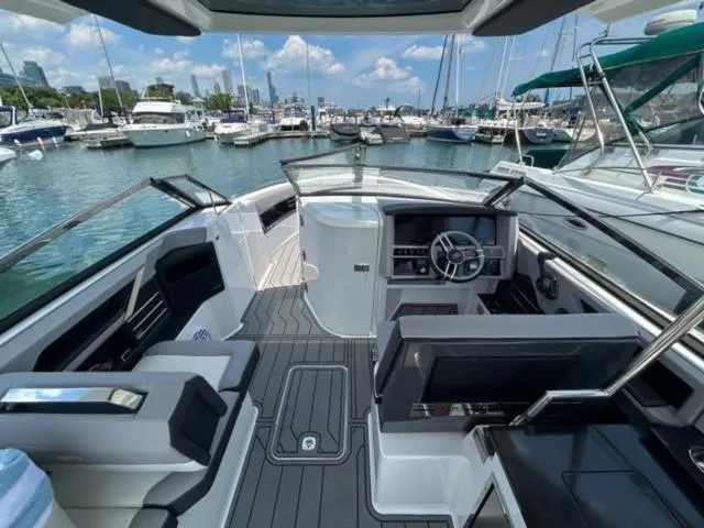 Slide: The Image of 2022 Cobalt A29 boat interior at a marina with other boats in the background. - 8