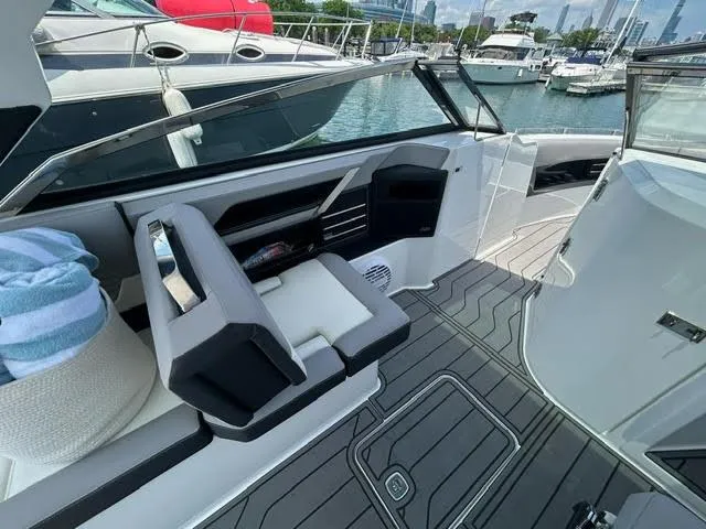 Slide: The Image of 2022 Cobalt A29 boat interior with seating and deck, docked at marina. - 9