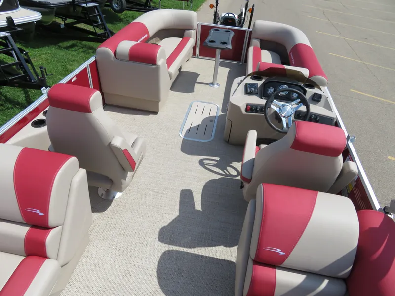 Slide: The Image of 2024 Bennington 22SSR pontoon boat interior with red and beige seating. - 13