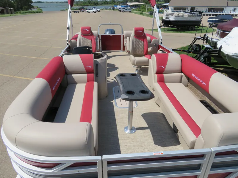 Slide: The Image of 2024 Bennington 22SSR pontoon boat with red and beige seating. - 6