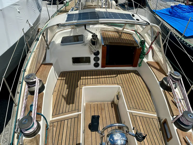 Slide: The Image of 1980 Alden 44 sailboat cockpit with wooden deck and solar panel. - 12