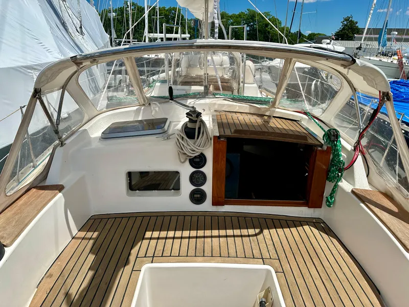 Slide: The Image of 1980 Alden 44 sailboat cockpit with teak flooring and navigation instruments. - 13