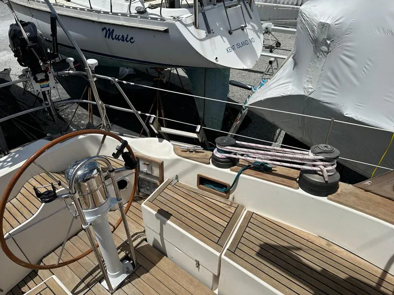Slide: The Image of Cockpit of 1980 Alden 44 sailboat with wooden deck and steering wheel. - 16