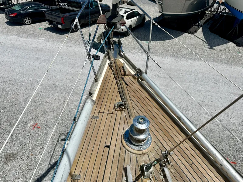 Slide: The Image of Bow of 1980 Alden 44 sailboat with wooden deck and anchor chain. - 18